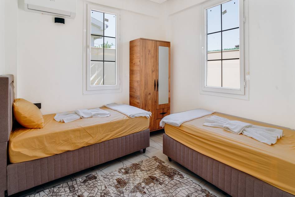 Modern wooden bunk beds with cozy bedding in a kid's room