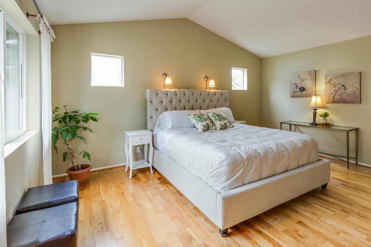 Space-efficient bunk beds for small bedrooms with under-bed desk and angled ladder